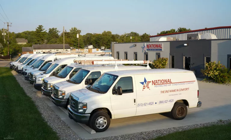 A row of National service vans parked outside of National's building
